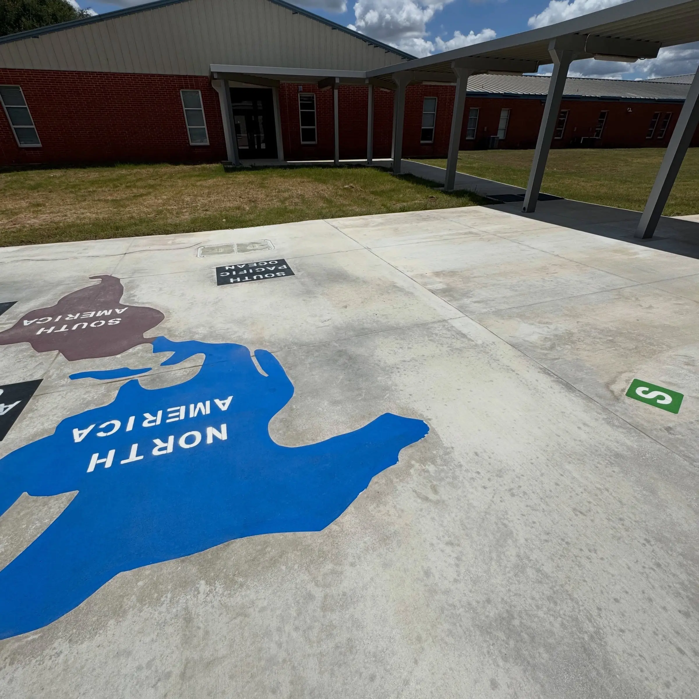 The same Blanco ISD map play surface after cleaning, the tire marks gone and the painted North and South America graphics intact